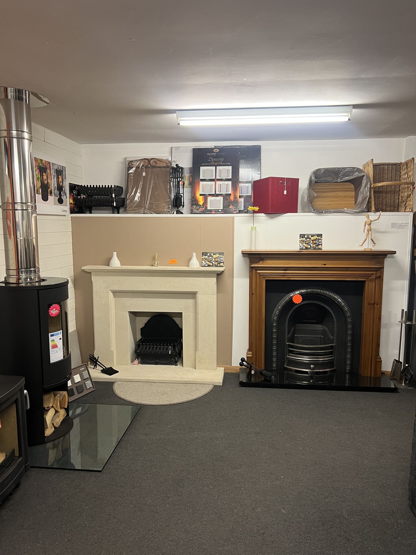 Cream stone surround and wooden fireplace with cast iron insert