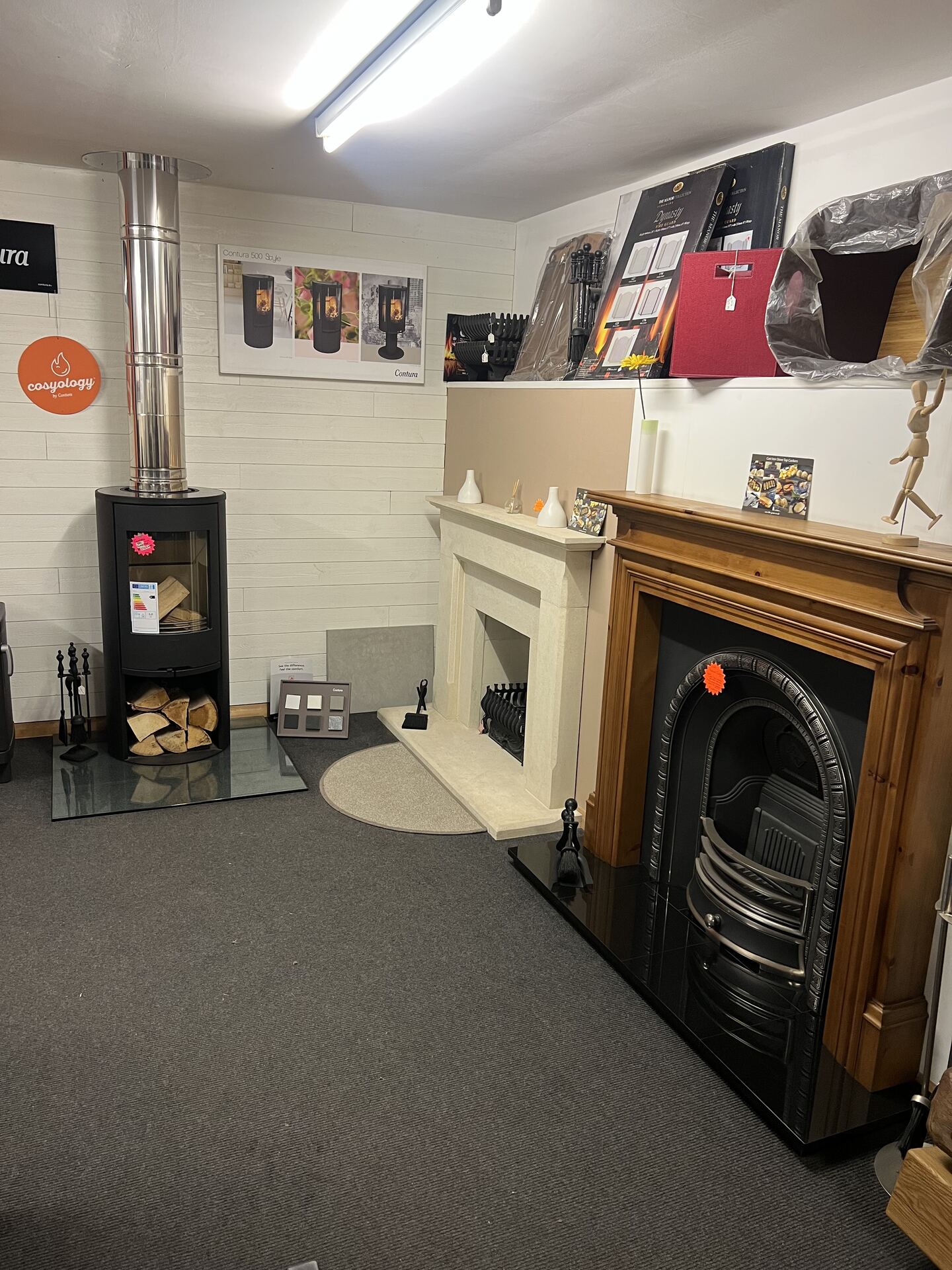 Cream stone surround, wooden fireplace insert and stove on display