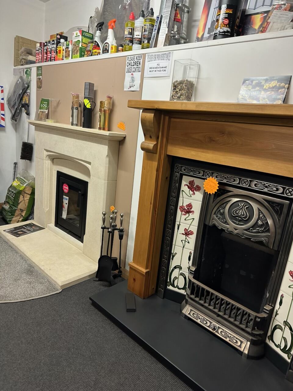 Cream stone surround next to a pine fireplace with floral tiles