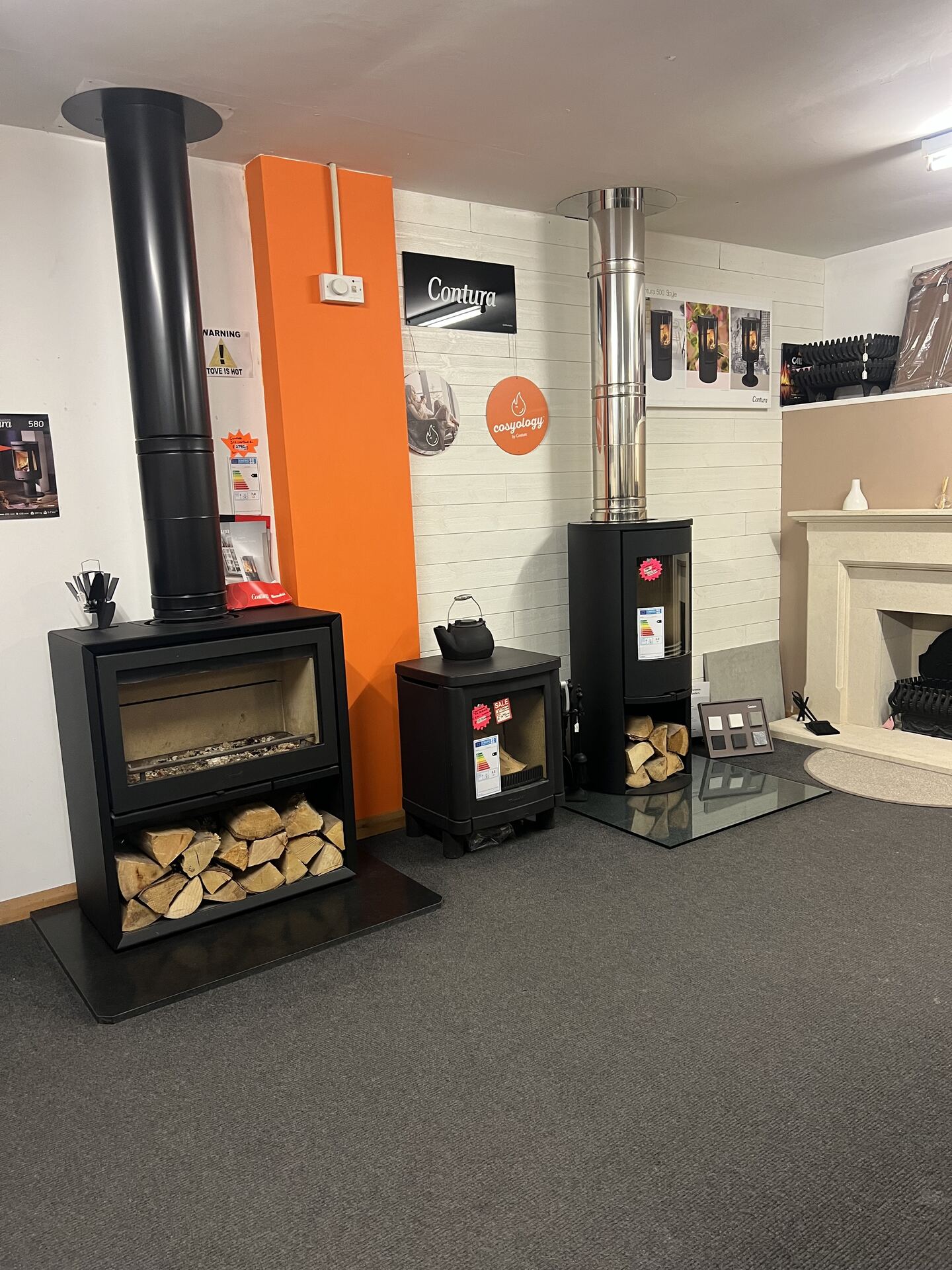 Showroom floor with stoves and a fireplace on display